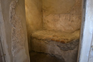 Una delle piccole stanze all'interno del lupanare di Pompei; visibile il letto in muratura